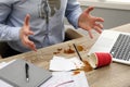 Man with spilled coffee over his workplace and shirt