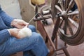 Man spinning wool on a traditional spinning wheel. Royalty Free Stock Photo