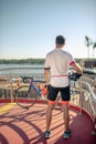 Man in sports cycling clothes standing with his back Royalty Free Stock Photo