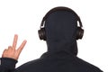 A man in a sports jacket with a hood on his head listens to music with headphones on his smartphone. Modern technologies - a smart Royalty Free Stock Photo