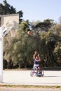 Man in sports wheelchair throwing basketball into hoop Royalty Free Stock Photo