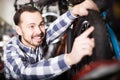 Man in sports workshop mounts bike using special tools