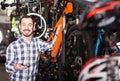 Man in sports workshop mounts bike using special tools