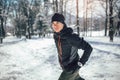 Man Taking Break From Running in Extreme Snow Conditions