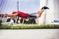 Man in sporty wear alone working out doing extreme pushups