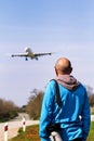 Man is looking at the plane which is landing Royalty Free Stock Photo