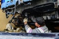Man spraying an anti-corrosion compound on bottom of car. Royalty Free Stock Photo