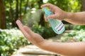 A man spraying insect and mosquito repellent to his hand in the outdoor Royalty Free Stock Photo