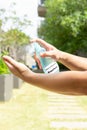 A man spraying insect and mosquito repellent to his hand in the outdoor at vertical composition Royalty Free Stock Photo