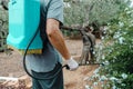 Man spraying insecticide from a knapsack sprayer