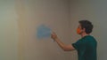 Man spraying paint on the wall. spray can in the hand. face in respirator Royalty Free Stock Photo