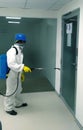 A man is spraying sanitizer for disinfecting COVID19 virus at office premises of construction site.