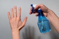 A man sprays his hands with an antiseptic from the pulverizer