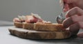 Man spread fig marmalade on ciabatta bread Royalty Free Stock Photo