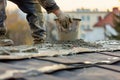 man spreading cement on a rooftop for waterproofing