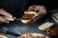 Man spreading vegan sobrasada on a piece of bread