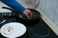 A man spreads pieces of bacon into a preheated frying pan Royalty Free Stock Photo