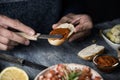 Man spreads vegan sobrasada on a piece of bread