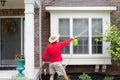 Man spring cleaning the exterior of his house