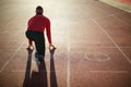 Man sprinters at starting position ready for race on racetrack