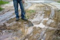 Man with spud on the muddy road