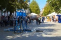 A man in the square does gymnastic exercises on uneven bars