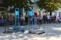 A man in the square does gymnastic exercises on uneven bars