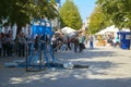 A man in the square does gymnastic exercises on uneven bars Royalty Free Stock Photo