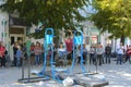 A man in the square does gymnastic exercises on uneven bars