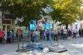 A man in the square does gymnastic exercises on uneven bars Royalty Free Stock Photo