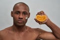 Man squashing an orange in his fist Royalty Free Stock Photo