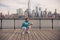 Man squats outdoor. Athletic Mature Fit Man Doing Exercises in City outdoor. Happy man workout in New York city. Senior