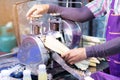 Man squeezes a sugar cane to make fresh, organic juice with a hand powered juicer. Healthy product Royalty Free Stock Photo