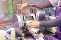 Man squeezes a sugar cane to make fresh, organic juice with a hand powered juicer. Healthy product Royalty Free Stock Photo