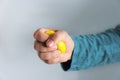 Man squeezing antistress ball on grey background