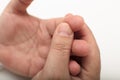 Man squeezing his finger after pricking it