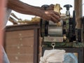 The man is squeezing juice from sugar cane. Using manual Mechanism for that Royalty Free Stock Photo