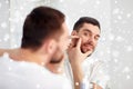 Man squeezing pimple at bathroom mirror Royalty Free Stock Photo