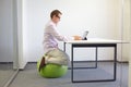 Man on stability ball working with tablet Royalty Free Stock Photo