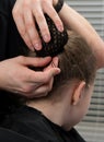 Man stabs hair bun under the net. metal studs, little girl. Royalty Free Stock Photo