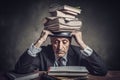 Man with a stack of books and clock on his head Royalty Free Stock Photo