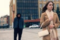 Man stalking young woman on city street Royalty Free Stock Photo