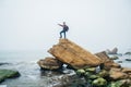 Man stand on cliff edge alone enjoying aerial view backpacking lifestyle travel adventure outdoor vacations Royalty Free Stock Photo