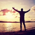 Man stand near beach looking at sunset, peaceful water level