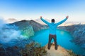 Man stand on rock above volcano Kawah Ijen acid lake