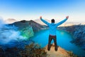 Man stand on rock above volcano Kawah Ijen acid lake