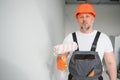 Man stand in the room with paint roller in his hand Royalty Free Stock Photo