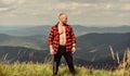 Man stand top mountain landscape background. Athlete guy relax mountains. Hiker muscular torso reach mountain peak Royalty Free Stock Photo