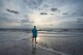 Man standing on the beach at sunrise. Royalty Free Stock Photo