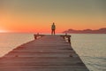 Man standing alone on the pier. Summer sunset sky in background Royalty Free Stock Photo